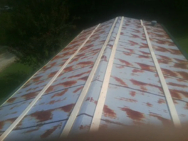 Rusted metal roof panels with new wood purlins before replacement — Storm Damage Roof Repair in Aripeka by Roofing Brothers